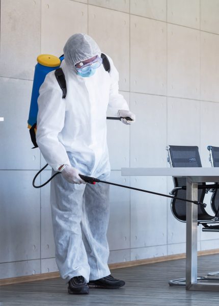 Cleaning and Disinfection at meeting room amid the coronavirus epidemic Professional teams for disinfection efforts Infection prevention and control of epidemic Protective suit and mask.